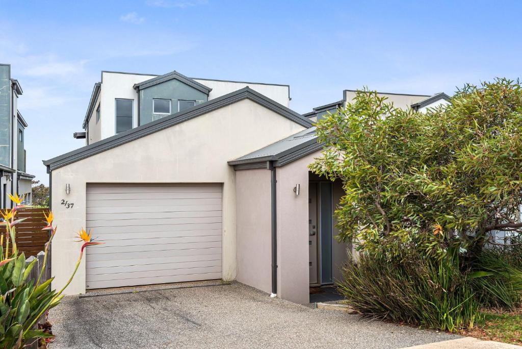 a white house with a garage at Eastern Views in Portarlington