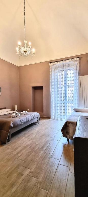 Hotel Casa Amedeo, a large bedroom with a bed and a chandelier at Casa Amedeo in Taranto