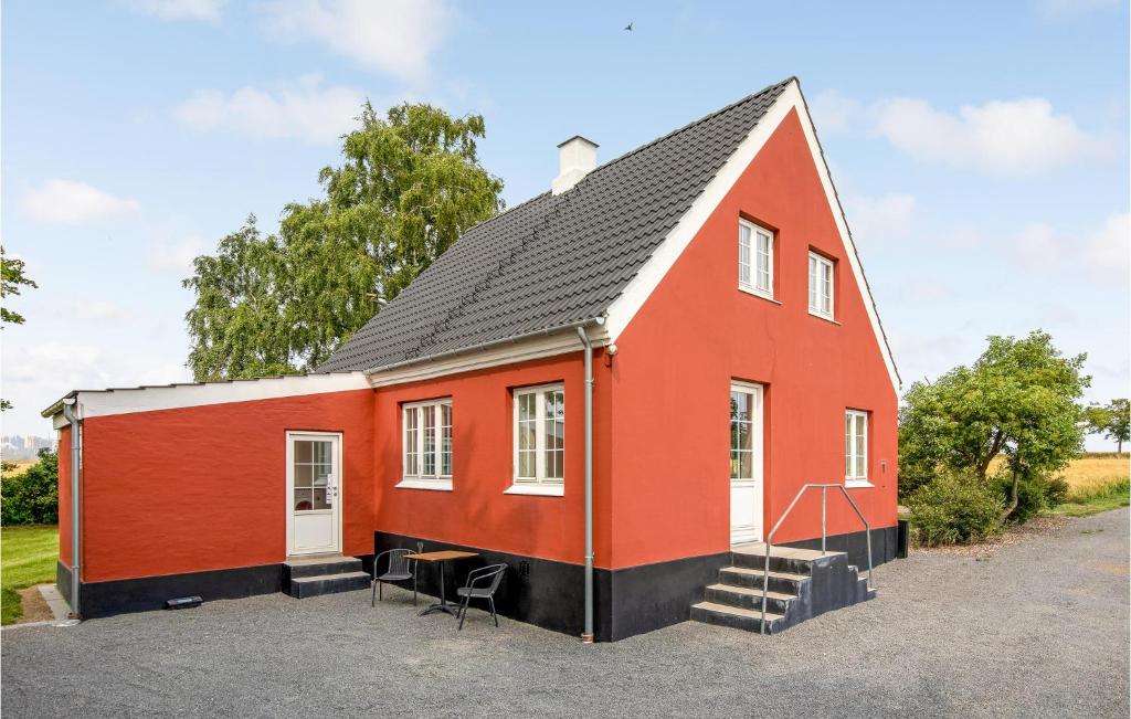 a red house with a black roof at Beautiful Home In Svaneke With Kitchen in Svaneke
