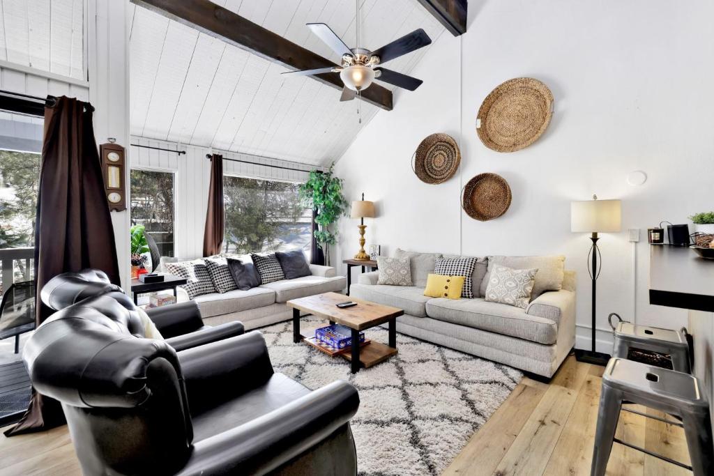 a living room with couches and a ceiling fan at 2125-Switzerland Slopes townhouse in Big Bear Lake
