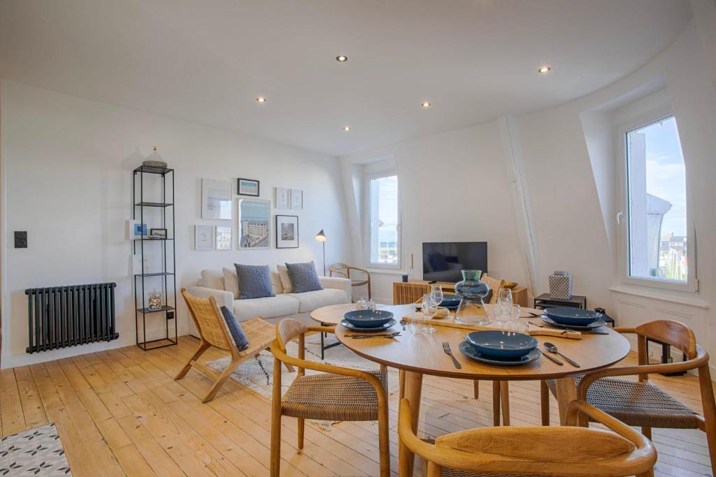 salon ze stołem i krzesłami w obiekcie La Villa Suzanne - Two Bedrooms - Deauville Beach w mieście Deauville