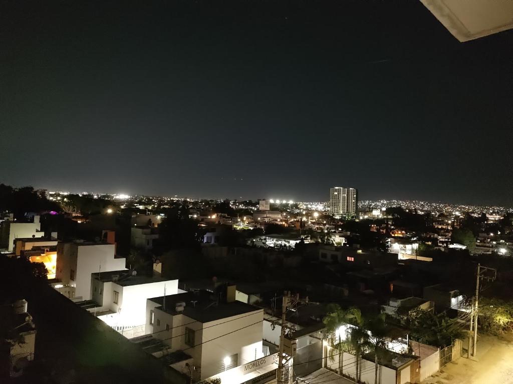 a view of a city at night with lights at Excelente Departamento céntrico. in Guadalajara