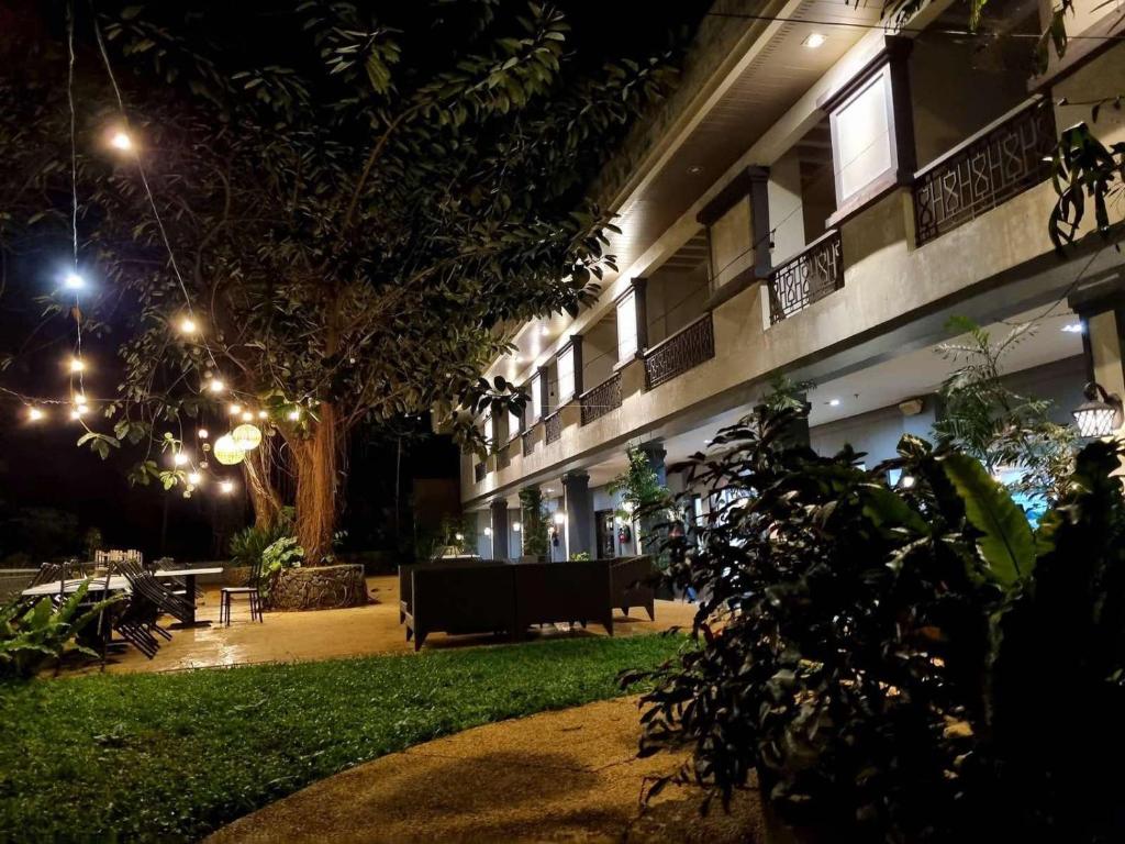 a courtyard of a building at night with lights at Momarco Forest Cove in Tanay
