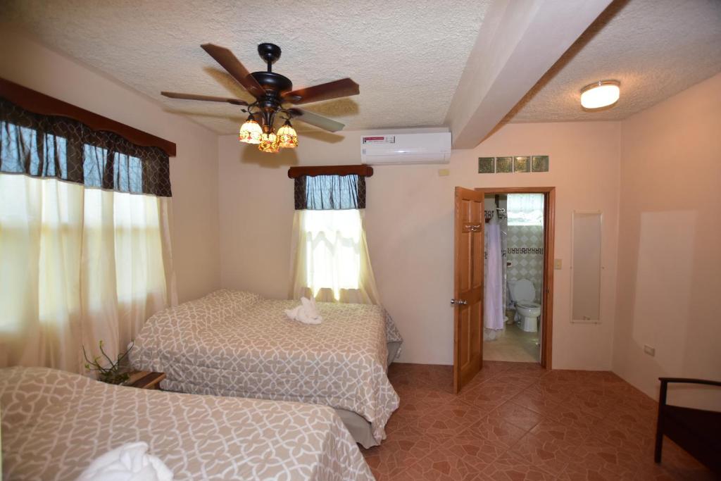 a bedroom with two beds and a ceiling fan at Harada Inn and Suites in Hopkins