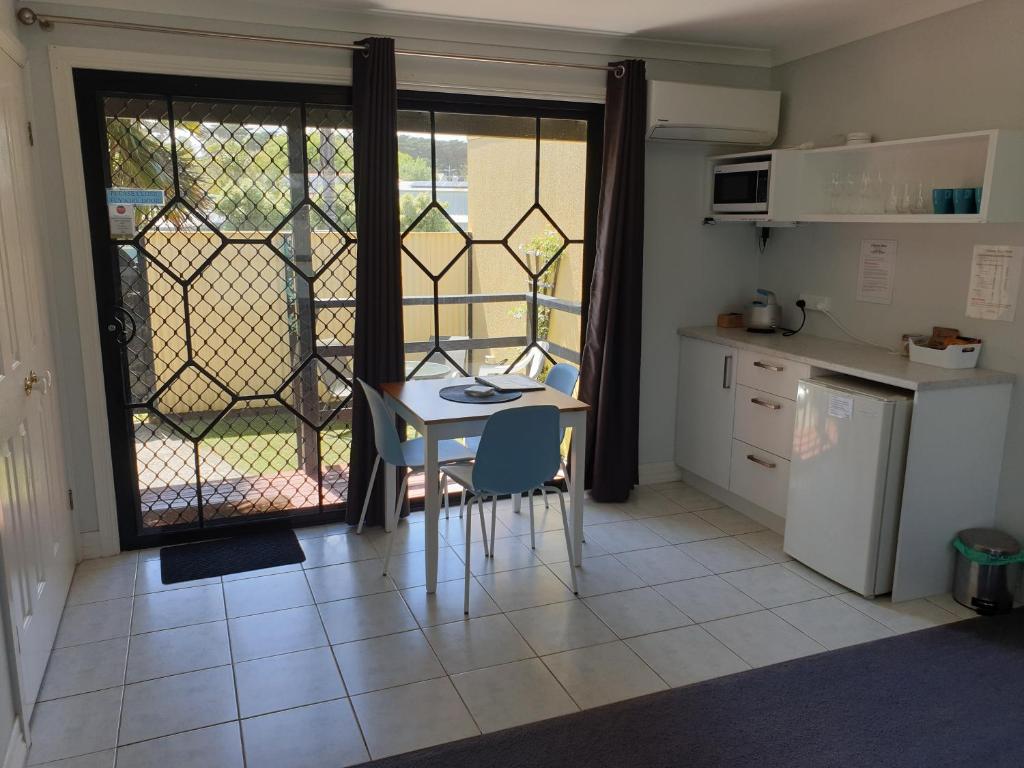 a kitchen with a table and chairs and a window at Chateau Bass in Bass