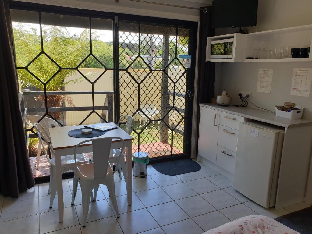 a kitchen with a table and a table and a window at Chateau Bass in Bass