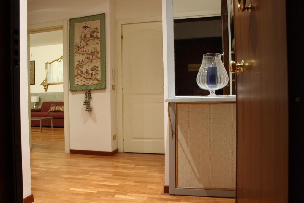 a kitchen with a wine glass on top of a counter at Appartamento blu centro storico in Bologna