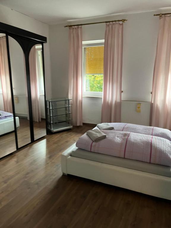 a bedroom with a bed and a large mirror at Pension Rüge in Frankfurt