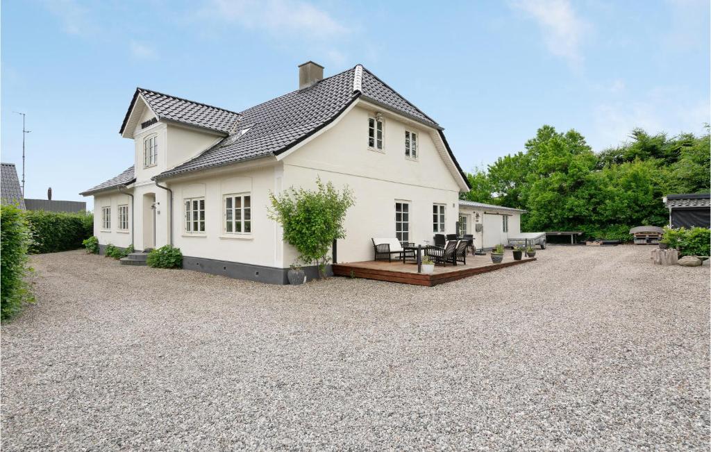 a white house with a gravel driveway at Awesome Apartment In Hejls With Kitchen in Hejls
