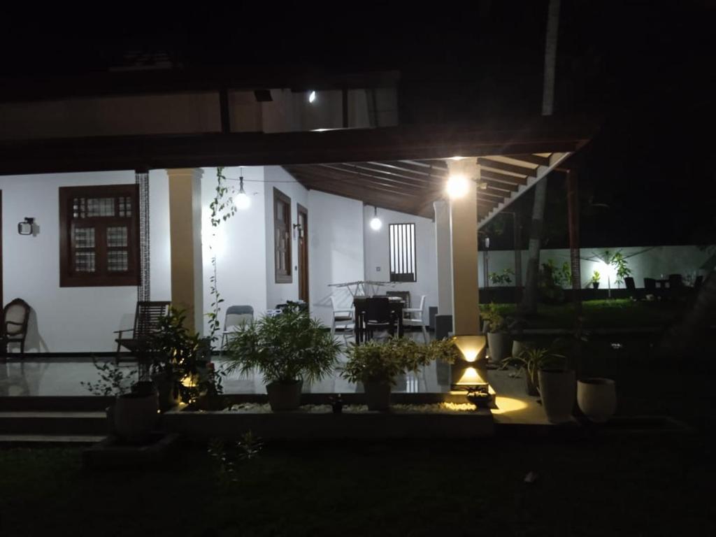 a house with a lit up porch at night at Airport Dulux Green Villa in Minuwangoda