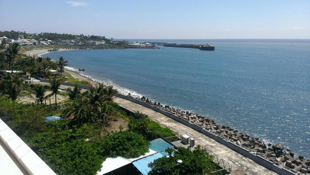 a view of a beach with a tanker in the water at Sea Bay in Taitung City