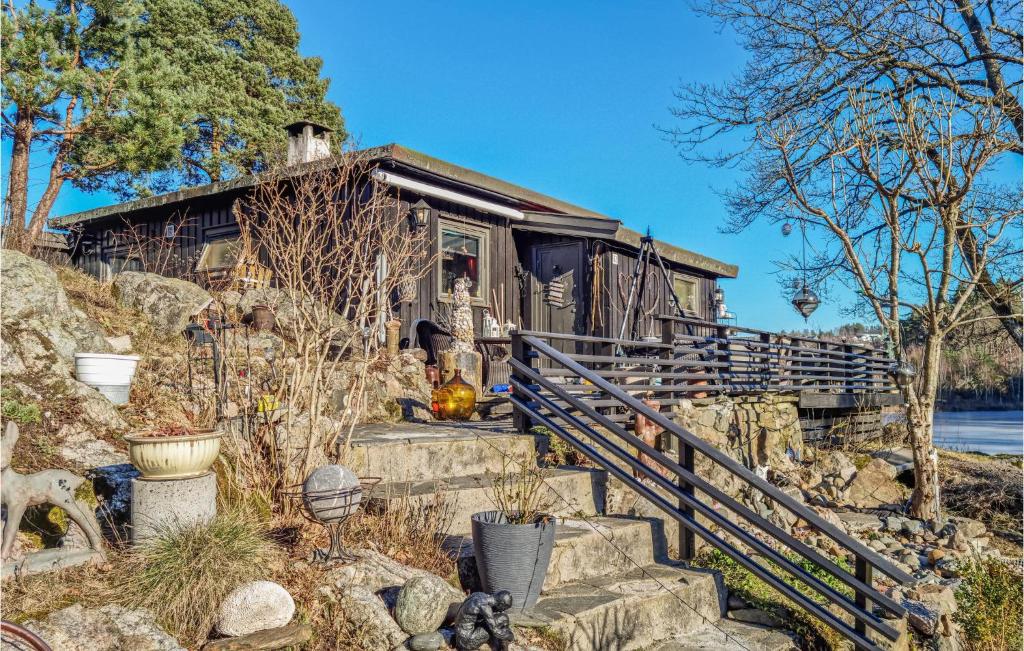 a tiny house on a rocky hill with stairs at 2 Bedroom Pet Friendly Home In Kristiansand in Kristiansand