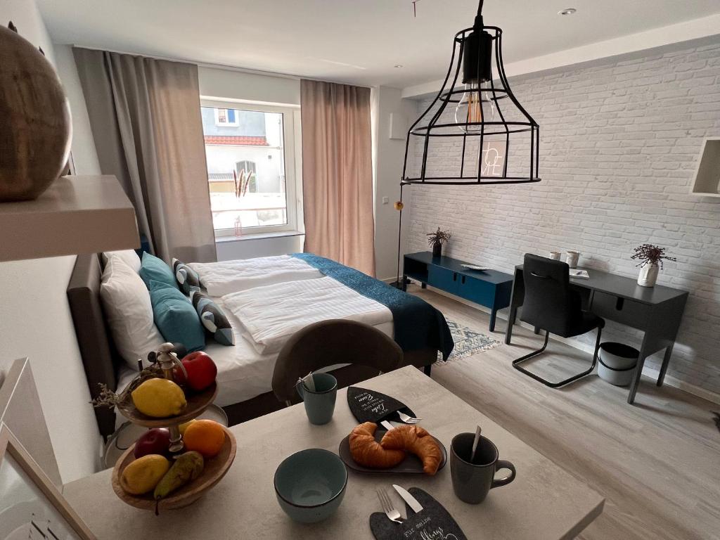 a bedroom with a bed and a table with fruits on it at SOFI-LIVING-APARTMENTS in Hannover