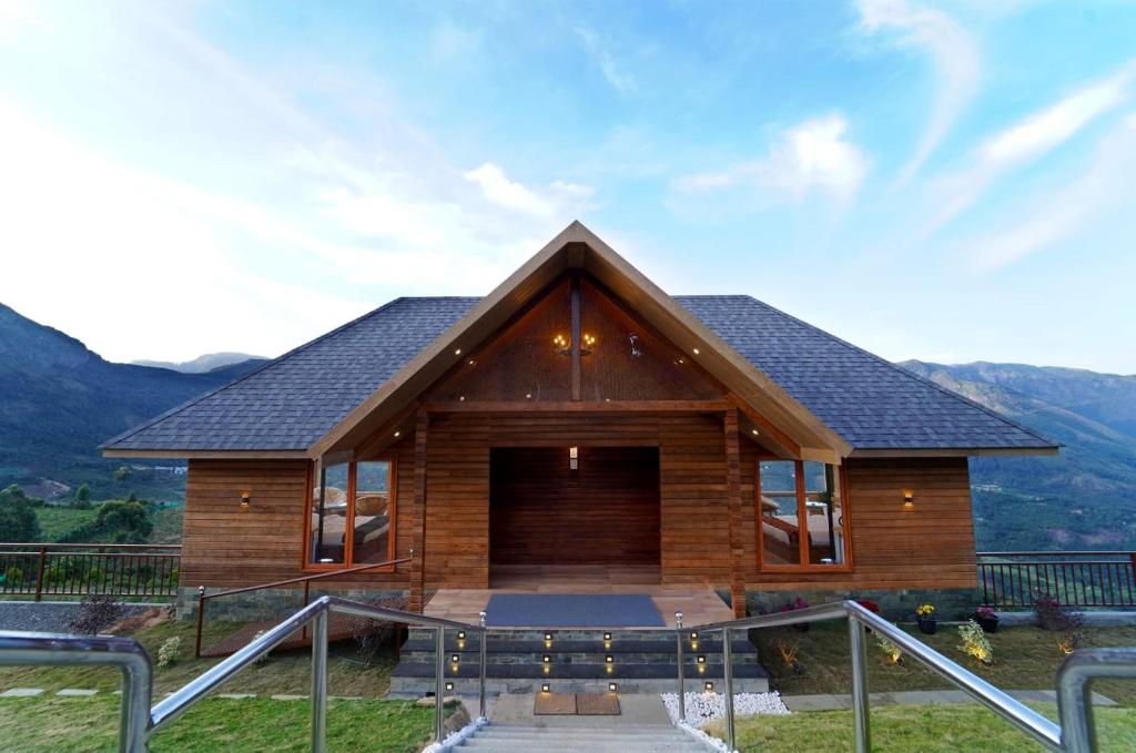 a log cabin with a view of the mountains at Vrindhavan Farm Suites in Kanthalloor