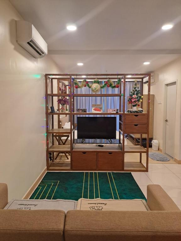 a living room with a couch and a tv at Timurbay Beach Resort Balok Kuantan in Kampung Sungai Karang