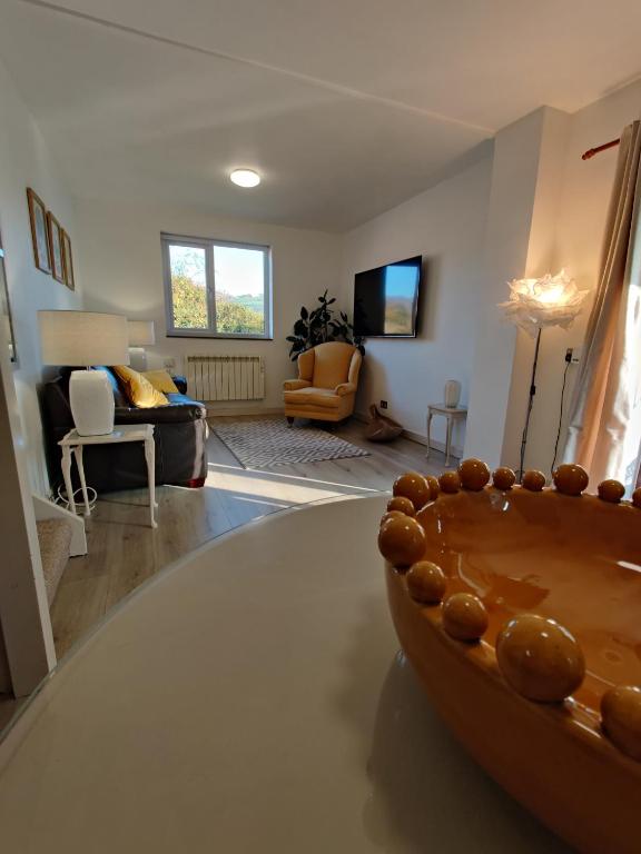 a living room with a bowl on top of a table at Owl's Watch in Ruthin