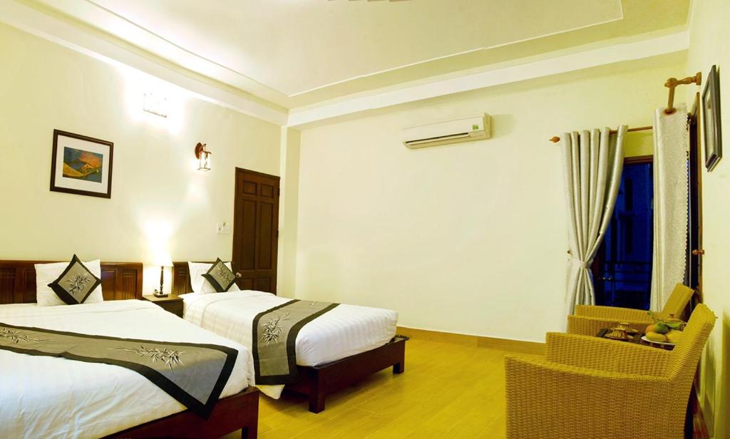 Postel nebo postele na pokoji v ubytování An Hoi Town Homestay