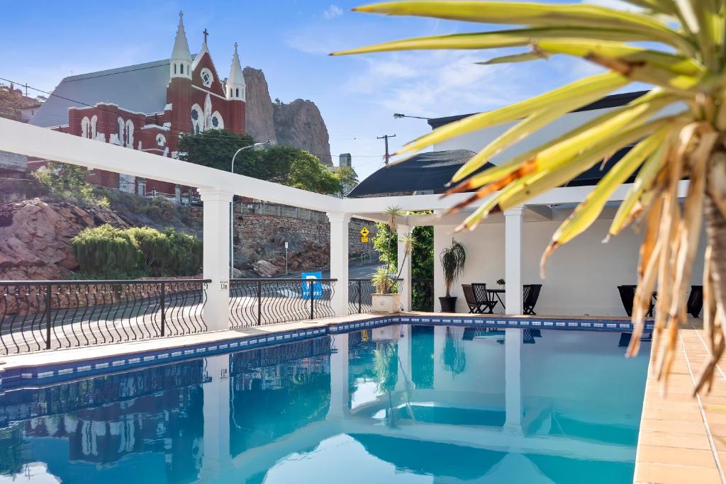 a swimming pool with a building in the background at The Robert Towns in Townsville