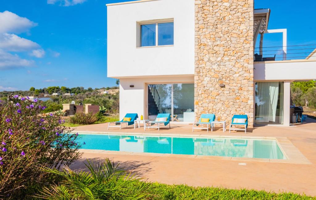 a villa with a swimming pool and a house at Villa Agape Luxury Leuca by HDSalento in Leuca