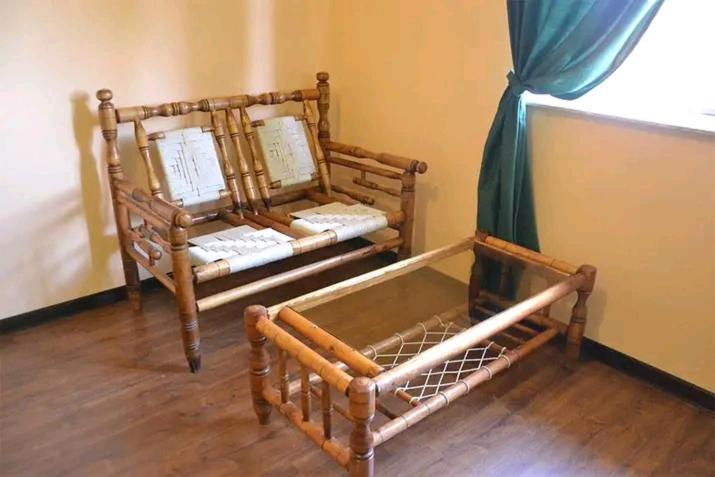two wooden beds sitting in a room with at Sevan Garden Complex in Sevan