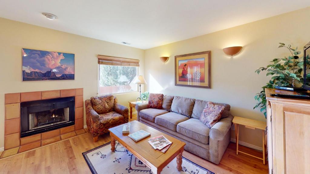 a living room with a couch and a fireplace at Kokopelli's Kiva #3230 in Moab