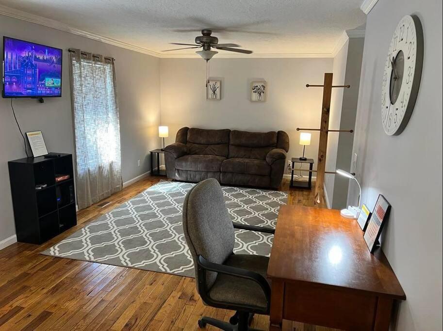 a living room with a couch and a table at Cozy 2 Bedroom Townhouse Near Lake and Restaurants in Guntersville