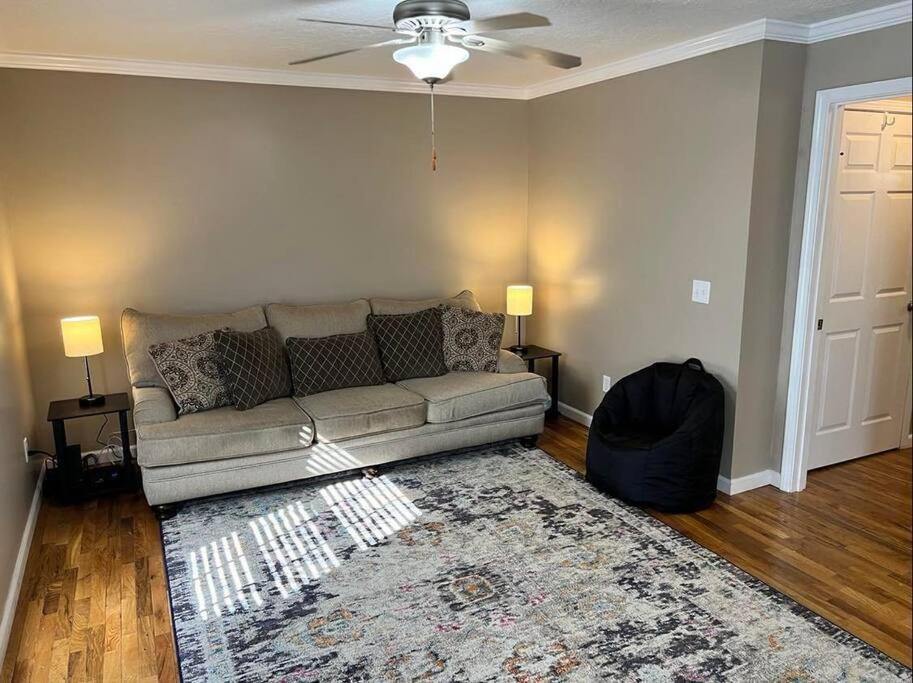 a living room with a couch and a rug at Comfy King Bed Townhouse with Outdoor Sitting Area in Guntersville
