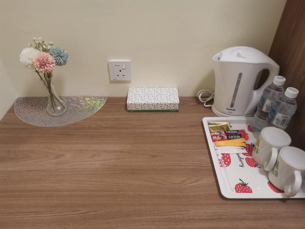 a counter with a coffee maker and a tray on a table at SCC Hotel Chinatown in Kuala Lumpur