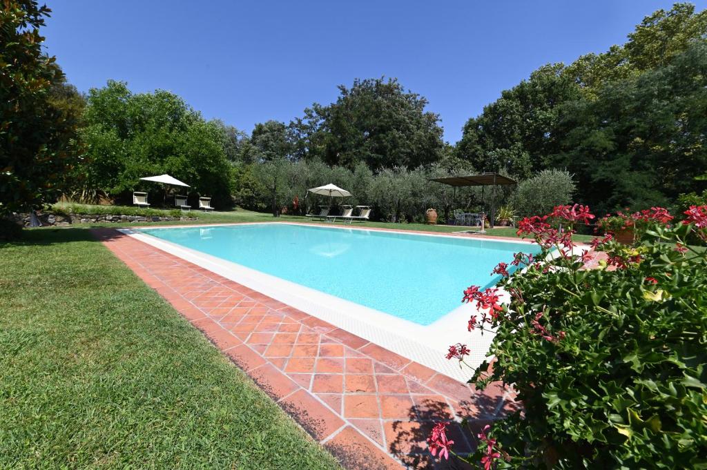 ein Schwimmbad in der Mitte eines Gartens in der Unterkunft Agriturismo Corte Stefani in Capannori