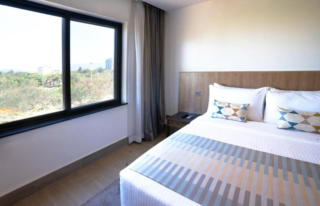 Postel nebo postele na pokoji v ubytování Sarova Imperial Hotel