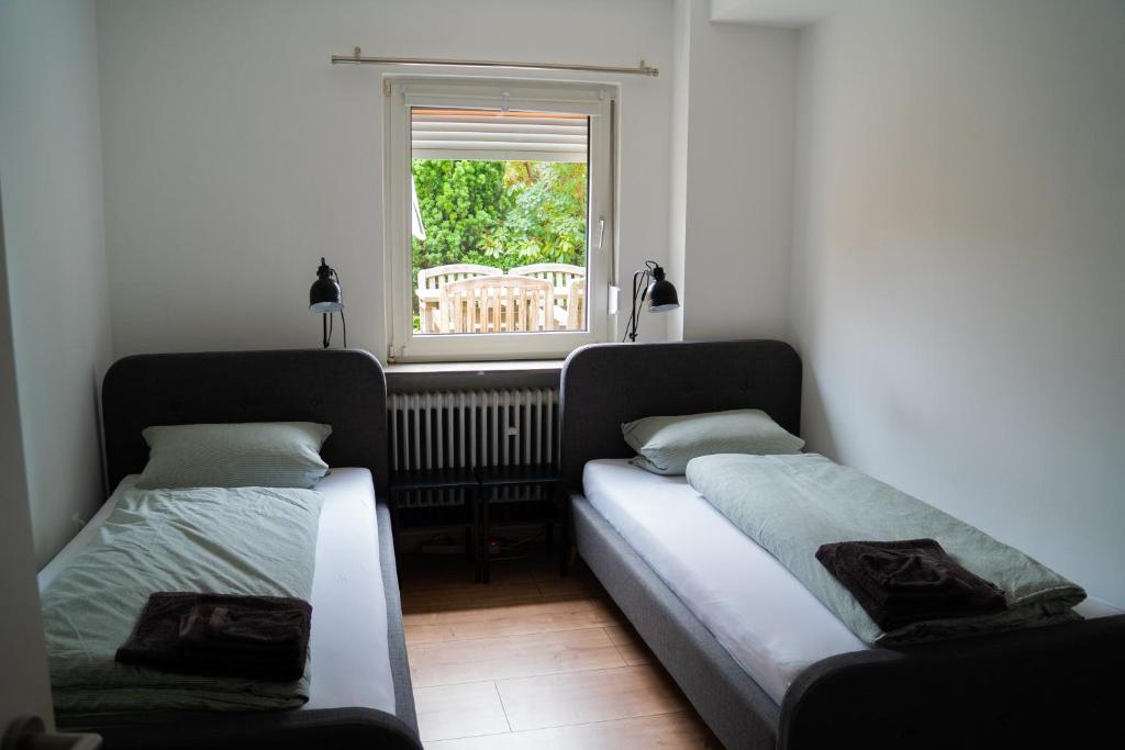 2 Betten in einem Zimmer mit Fenster in der Unterkunft Appartement No 5 in Weimar