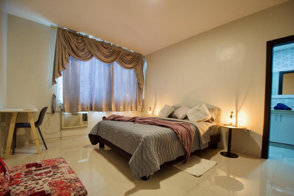 1 dormitorio con cama y ventana grande en Pepe's House Guayaquil I MicroHostel Self Check-In, en Guayaquil