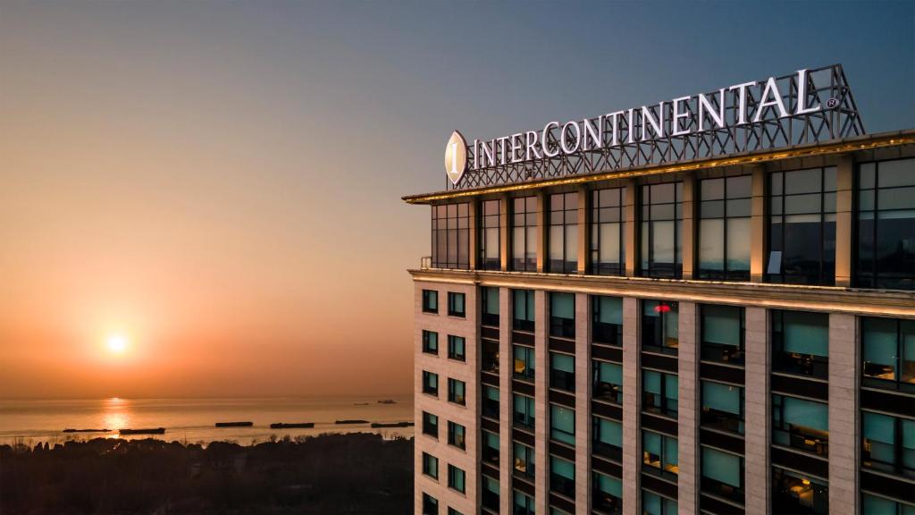 a building with a sign on top of it at InterContinental Nantong, an IHG Hotel-Best view of yangtze in Nantong