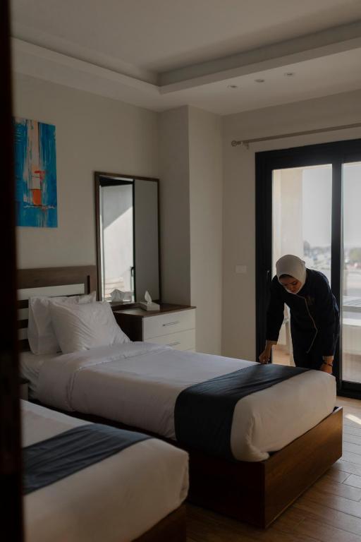 Postel nebo postele na pokoji v ubytování Royal Inn Residence New Cairo