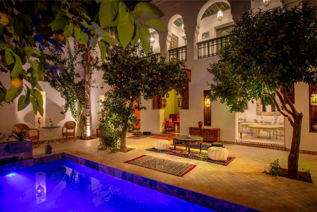 a pool in the middle of a room with trees at Riad les remparts de la kasbah in Marrakesh