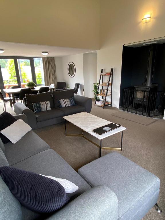 a living room with a couch and a table at *** LAKE VILLA 467 *** in Hanmer Springs