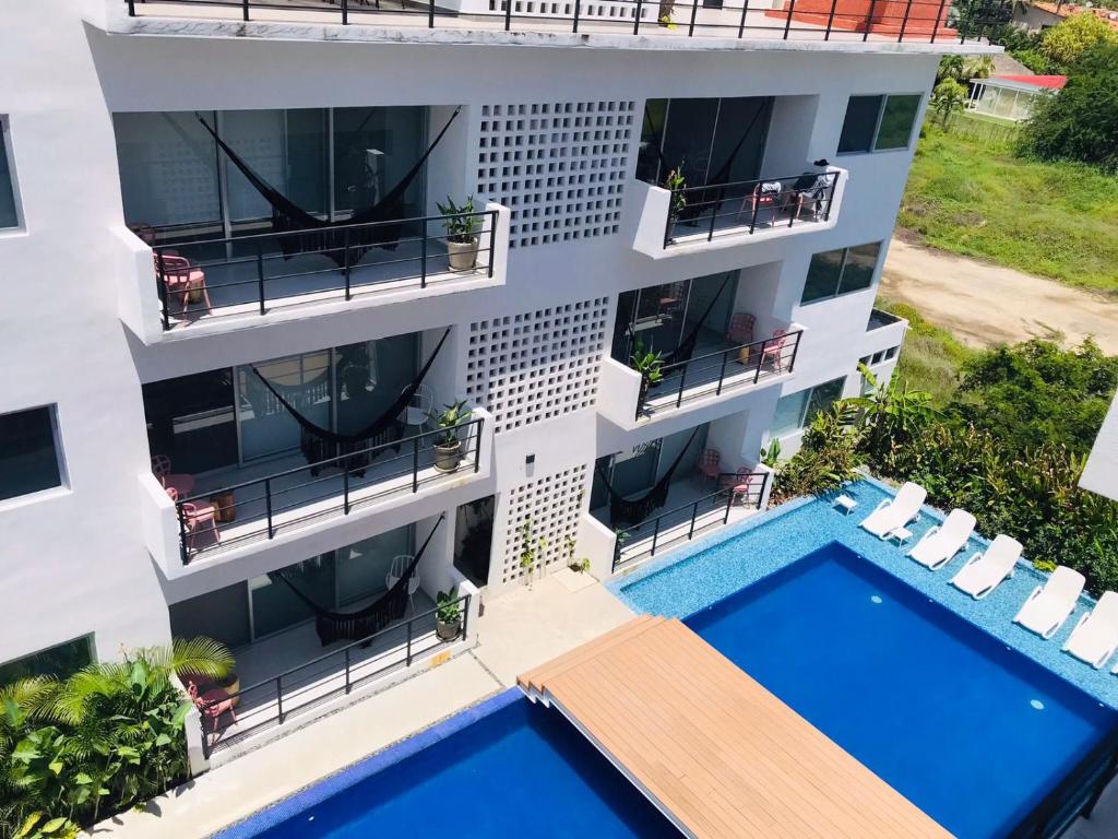 an aerial view of a building with a swimming pool at Papaya Condo Acapulco Diamante -Solo Adultos in Acapulco
