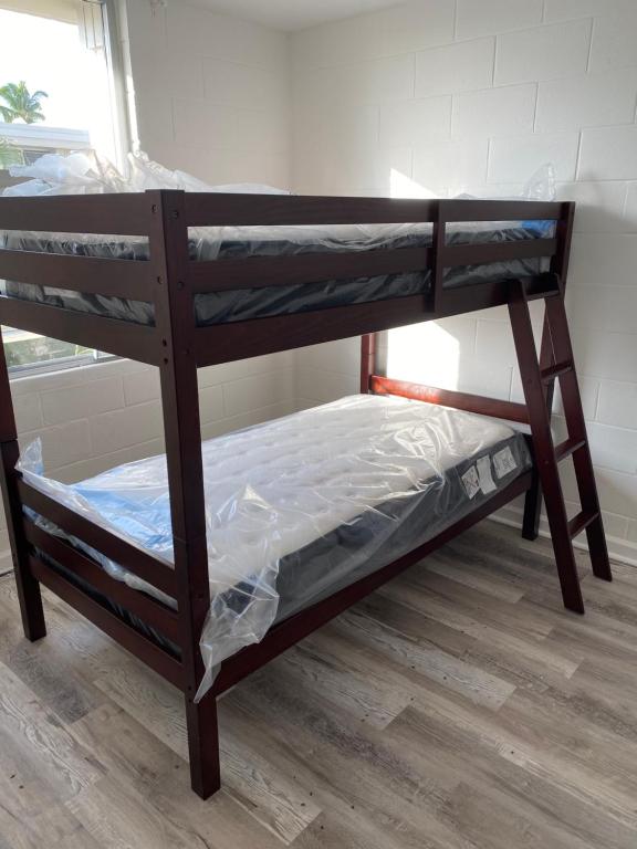 a wooden bunk bed in a room at Pearlridge Gardens and Tower Aiea, Hawaii 96701 in Aiea