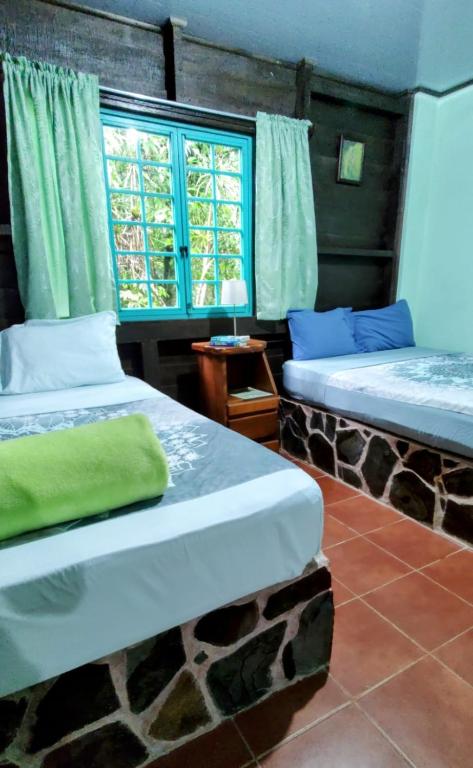 Postel nebo postele na pokoji v ubytování Cecropia Ecolodge
