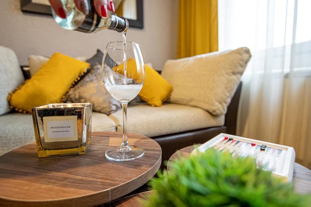 a wine glass on a table in a living room at Studio Stankovic Royal Towers 326 in Bansko