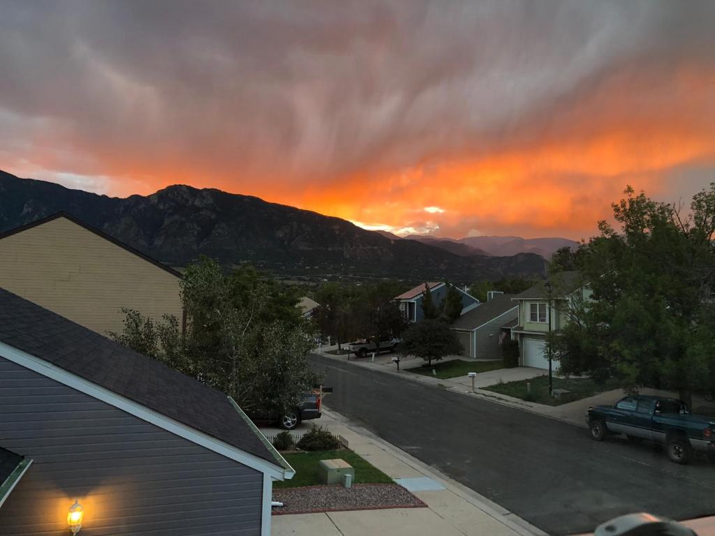 a view of a sunset from a residential street at A Colorado Room With a View - King in Colorado Springs
