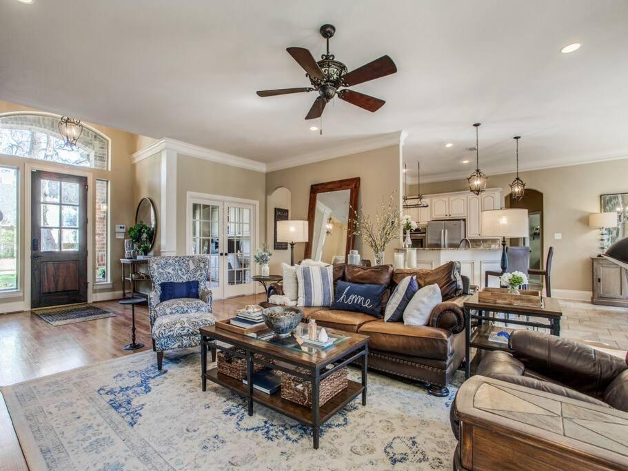 a living room filled with furniture and a ceiling fan at Executive home w/Study + pool near Lake in Rockwall