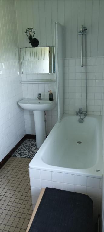 a white bathroom with a sink and a tub and a bath tub at L&#39;auberge 10 à 15 pers 30min zoo beauval chambord cheverny in Langon