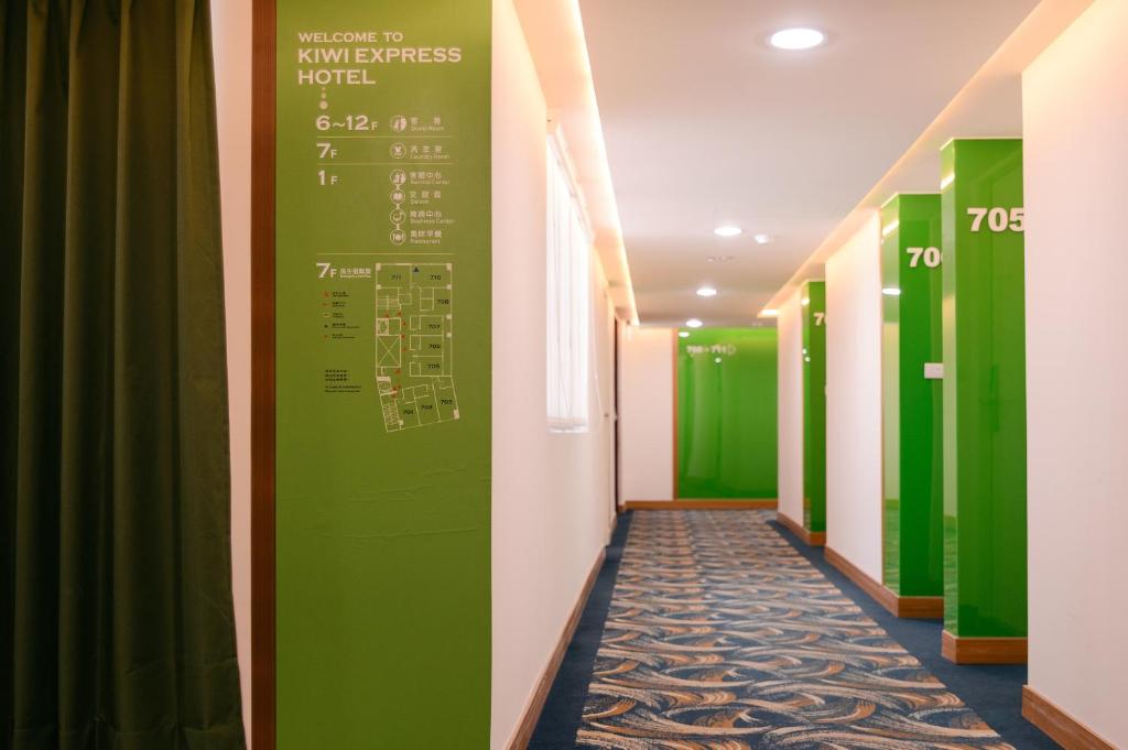 a corridor of a hospital with green walls at KIWI-Taichung Station Branch 1 in Taichung