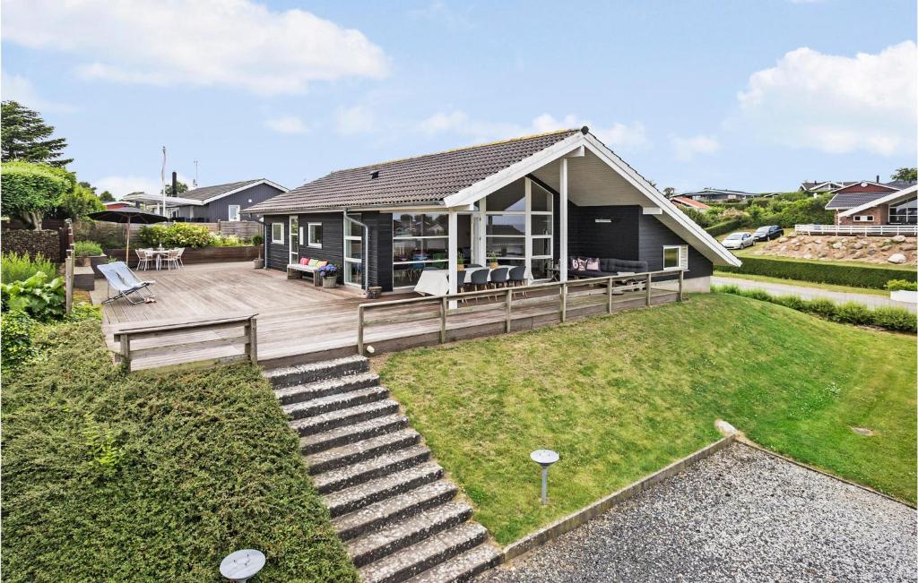 a house with a deck and a yard at Pet Friendly Home In Hejls With Wifi in Hejls