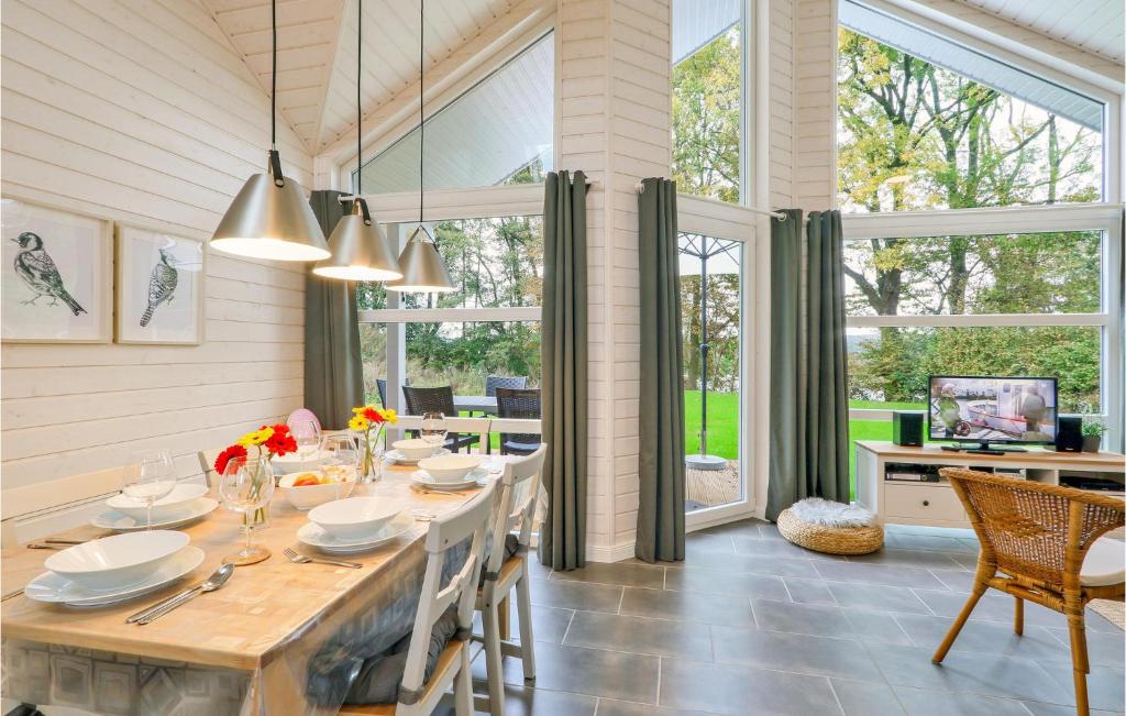 a dining room with a table and a large window at Beautiful Home In Krems Ii-warderbrck With Sauna in Göls