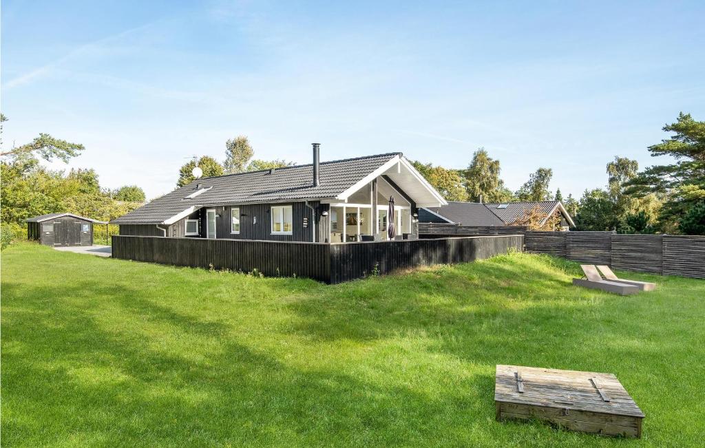 a house sitting on top of a lush green field at Stunning Home In Nex With Sauna in Neksø