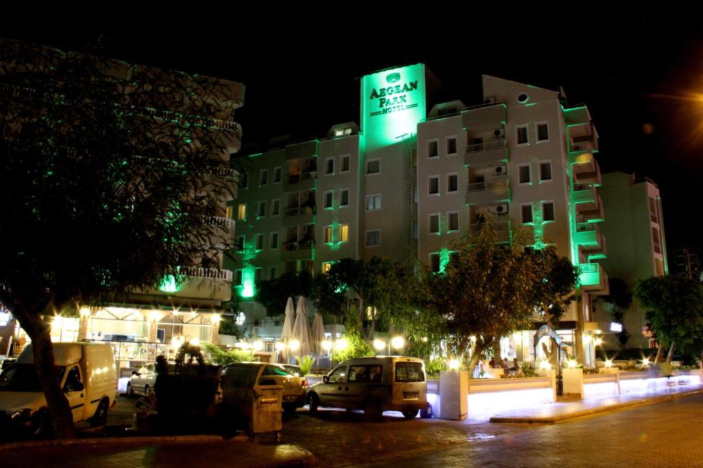 a building with a green sign on it at night at Aegean Park Hotel in Marmaris