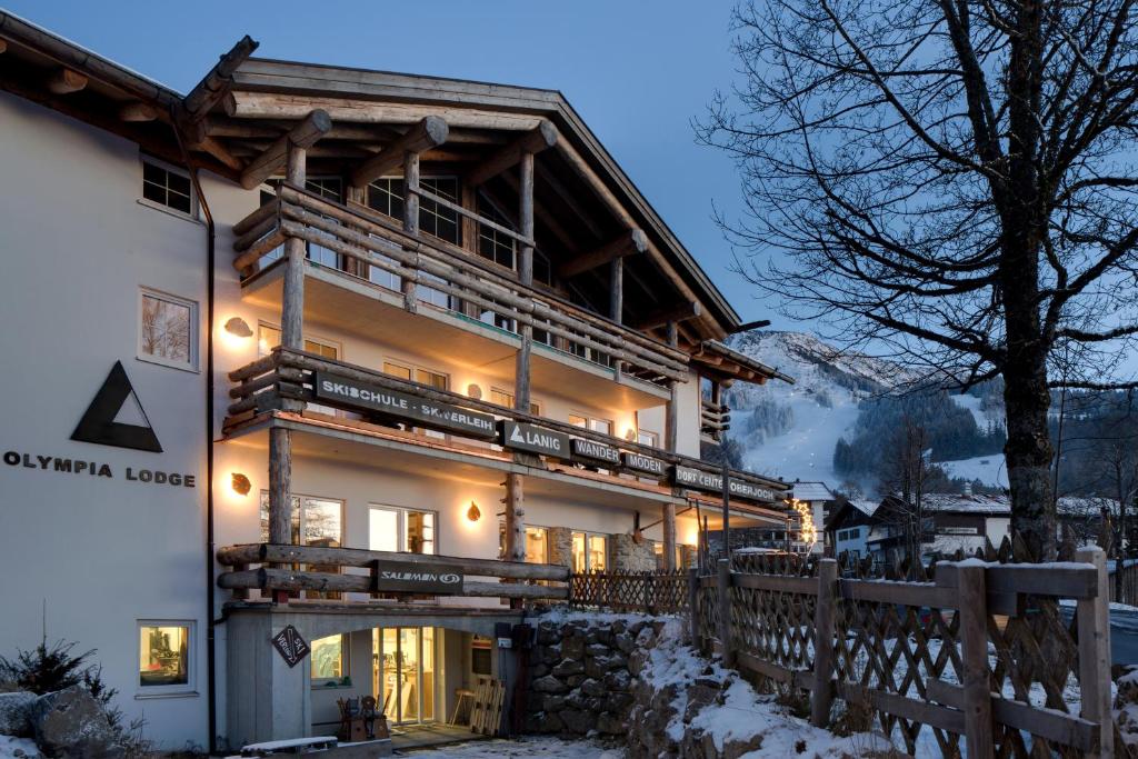 a house in the snow with a wooden fence at MOUNTAIN LODGE OBERJOCH, BAD HINDELANG - moderne Premium Wellness Apartments im Ski- und Wandergebiet Allgäu auf 1200m, Family owned, 2 Apartments mit Privat Sauna in Bad Hindelang