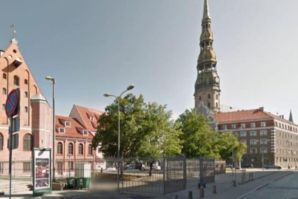 a city with a tall clock tower in the background at In the heart of old Riga in Riga